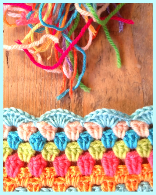 colourful granny stitch blanket with shell stitch border